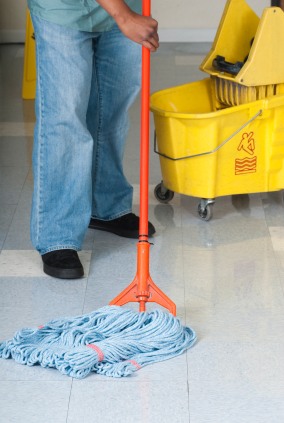 Russell Janitorial LLC janitor in Berkeley, CA mopping floor.